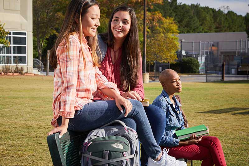 Teen girls ignoring black classmate at school